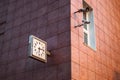 Clock on the wall on the street and cameras