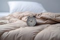 Clock on a warm blanket. The concept of morning awakening