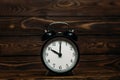 Clock on a wooden background. The clock shows the time of ten o`clock in the afternoon. Clock showing the time of ten o`clock in Royalty Free Stock Photo