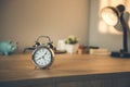 Clock on the  working wooden  table. Royalty Free Stock Photo