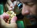 Clockmaker carefully repair antique pocket-watch