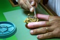 Clockmaker repairs antique golden pocket watch in his laboratory