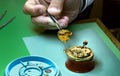 Clockmaker repairs antique golden pocket watch in his laboratory Royalty Free Stock Photo