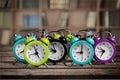 Many alarm clocks on wooden table