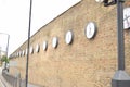 Clocks on a high brick wall at the train station