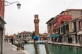 Clocktower, colorful houses and canal on the island of Murano near Venice