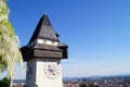 Clocktower in the light of the setting sun, background Graz