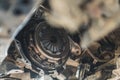 Cloe-up shot of a car clutch with a blurred shape in the foreground. Repair shop concept.