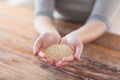 Cloes uo of female cupped hands with quinoa