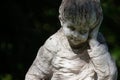 Cloes up photo of arden stone sculpture of a childern. Children statue.