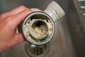 Clogged sink pipe,in the hands of a clogged dirty sewer pipe from leftover food Royalty Free Stock Photo