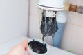 Clogged sink pipe. Unclog a drain from hairs and other stuff. Checking Hydraulic trap for draining water under the sink Royalty Free Stock Photo