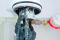 Clogged sink pipe. Unclog a drain from hairs and other stuff. Checking Hydraulic trap for draining water under the sink Royalty Free Stock Photo