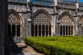 Cloister of the Dominican Monastery of Batalha in Portugal. Decorated columns and arches with inner garden. Partial view in full Royalty Free Stock Photo