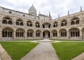 cloister of the monastery of los jeronimos with its balconies with gothic style arches and a fire in the center of the temple, Royalty Free Stock Photo