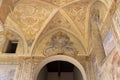 Cloister Santa Chiara, view of corridor under arcades and decorated colorful frescoes, Naples, Italy