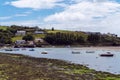 The coast of Ireland. Small fishing boats are anchored in bay at low tide. Picturesque seascape