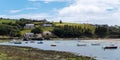 The sunny coast of Ireland. Small fishing boats are anchored in Clonakilty Bay at low tide.