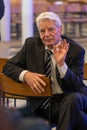 Former Federal President Joachim Gauck sits sideways on a chair while talking