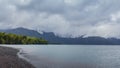 Clos to the lake. Hiking adventure on Osorno Volcano in Los Lagos Region of Chile. .Windy and rainy weather makes Royalty Free Stock Photo