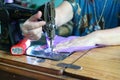 Close up Asian women hand Capturing fine fabrics, purple, sewing, cutting women Vintage cloth sewing machine Pattern design