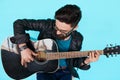 Close Bearded hipster man playing on acoustic guitar.