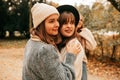 Close best friends sisters reunion after quarrel, argue, long time no see, embracing, missing, forgiving in autumn park. Royalty Free Stock Photo