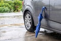 Close blue Umbrella folding with grey car