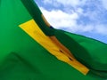 Close of brazilian flag fluttering in a blue sky