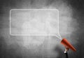 Hand of businesswoman holding red paper trumpet and speech cloud