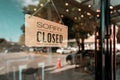 Close sign board on glass door in modern cafe coffee shop