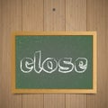 Close. Chalk board with wooden frame on a wooden background