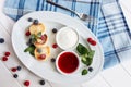 Close cheese pancakes, syrniki, curd fritters with fresh raspberries on white plate background. Top horizontal view.