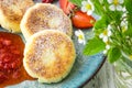 Close cheese pancakes, syrniki, curd fritters with fresh strawberries on plate background