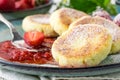 Close cheese pancakes, syrniki, curd fritters with fresh strawberries on plate background