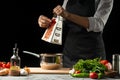 Close the chef& x27;s hands, preparing an Italian tomato sauce for macaroni.pizza. The concept of the Italian cooking recipe