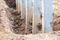 Close-concrete pillars installed in a trench dug soil