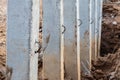 Close-concrete pillars installed in a trench dug soil