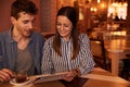 Close couple sharing while in restaurant