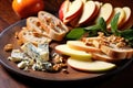 a close crop of apple slices, crumbled gorgonzola, and a bruschetta slice on a rustic plate