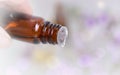 Essential oil bottle pouring of oil on blury background