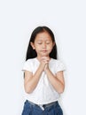 Close eyes beautiful little asian child girl praying isolated on white background. Spirituality and religion Royalty Free Stock Photo