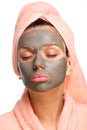 Close face of young woman with a mud mask on it. Royalty Free Stock Photo