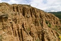 At close of the famous Stob Pyramids with unusual shape red and yellow rock formations, green bushes and trees around