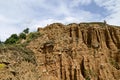 At close of the famous Stob Pyramids with unusual shape red and yellow rock formations, green bushes and trees around