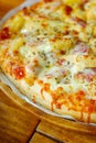 Close focus on homemade hawaiian pizza covered after baking from oven