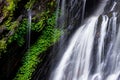 Close focus on smooth flowing water from high rock waterfall Royalty Free Stock Photo