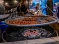 Meatballs cooking over hot coals in a street vendors wagon at the Christmas Market in the city of York, UK