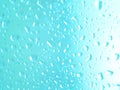 Close focus on water drop on colorful glass. Close focus on water drop on colorful window glass in blue and pink Royalty Free Stock Photo