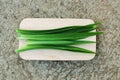 Close up the freshness of green pandan leaves on the wood cutting board, old cement background